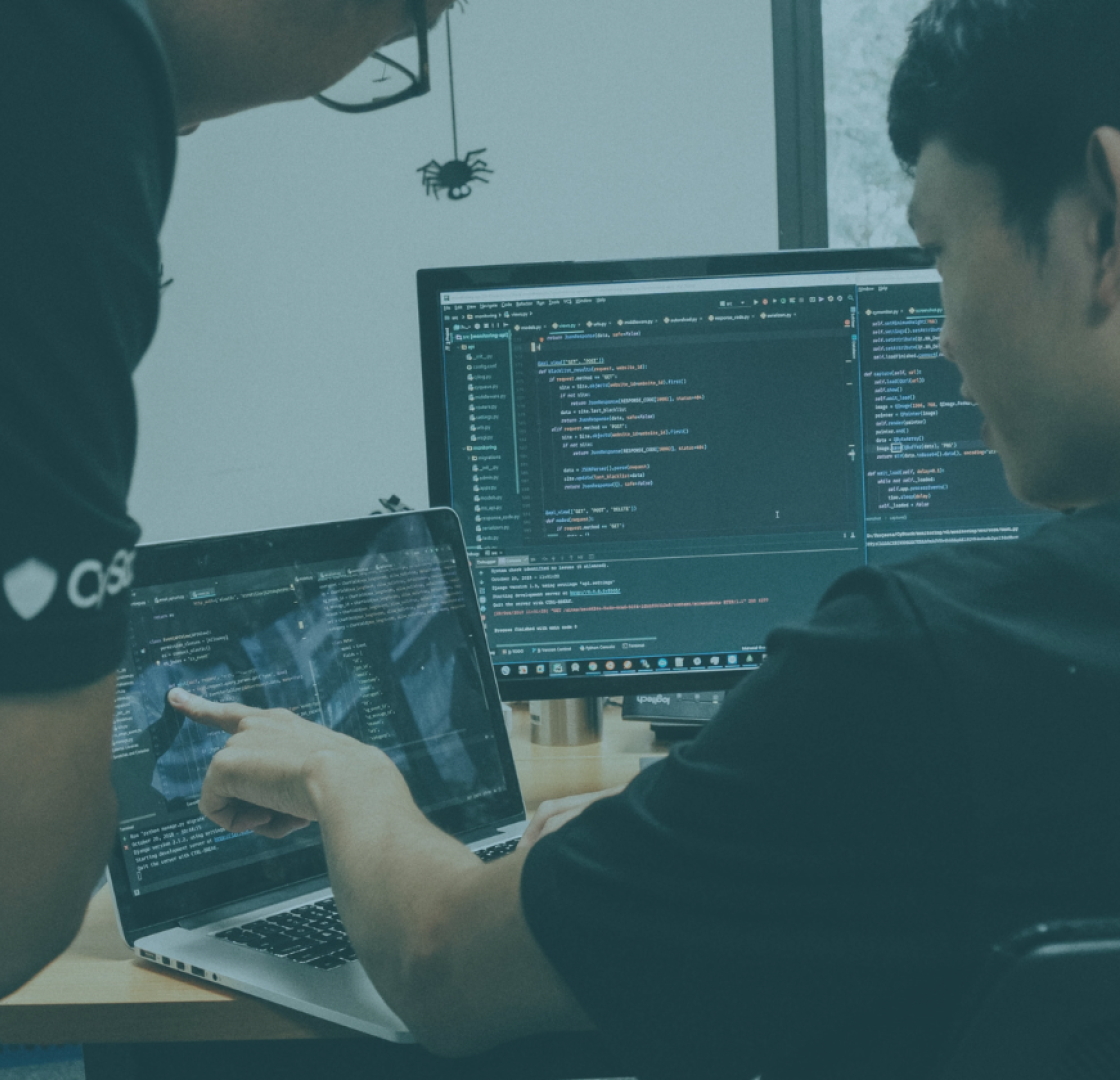 A pair of men looking at a computer screen