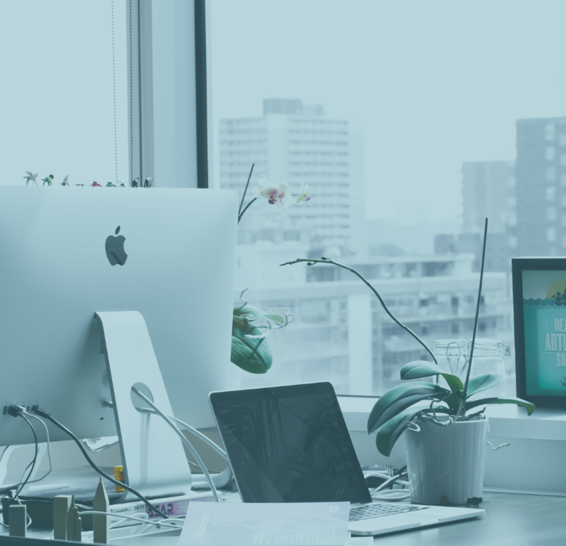 A computer and an iPad in a high-rise office 