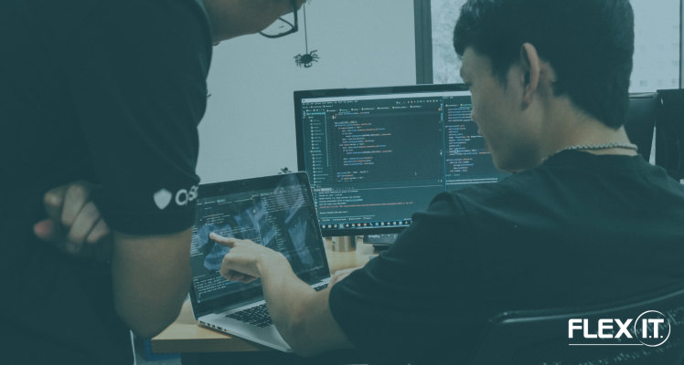 A pair of men looking at a computer screen